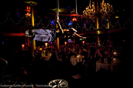 Patrons of both genders howl and swoon at the sight of aerialist Stephen Williams in chains