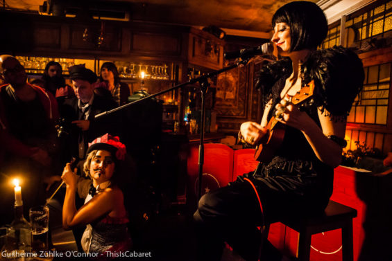 Patrons at The George Tavern enjoy an intimate number by EastEnd Cabaret on ukulele and musical saw